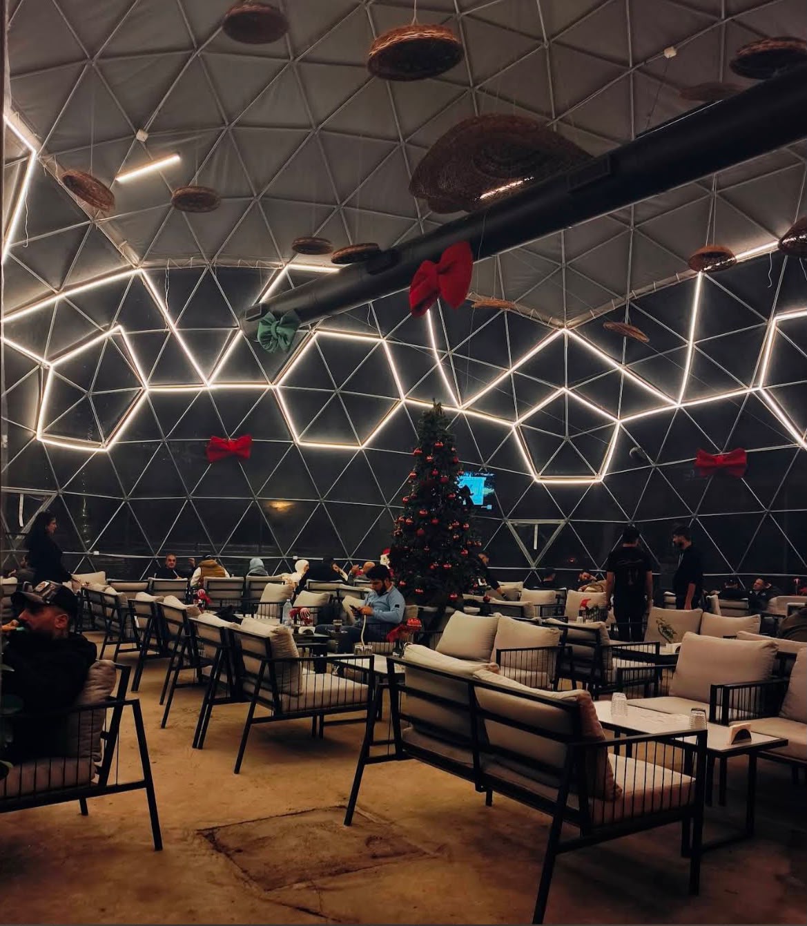 Evening seating inside the illuminated Saif Cafe dome
