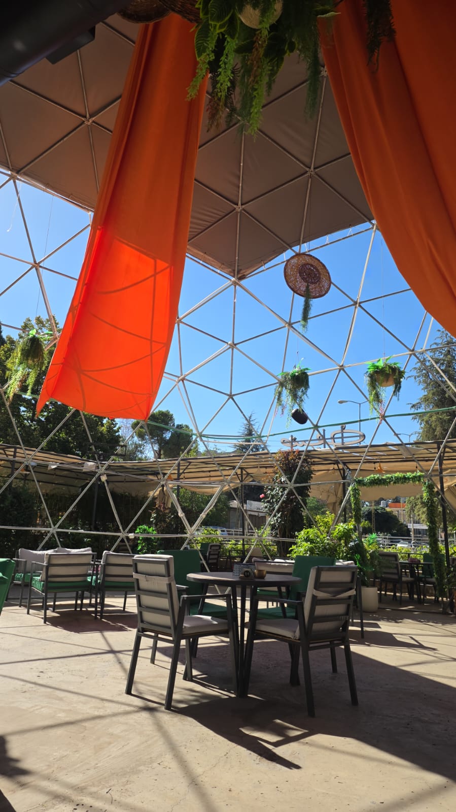 Sunlit seating beneath the distinctive Saif Cafe dome